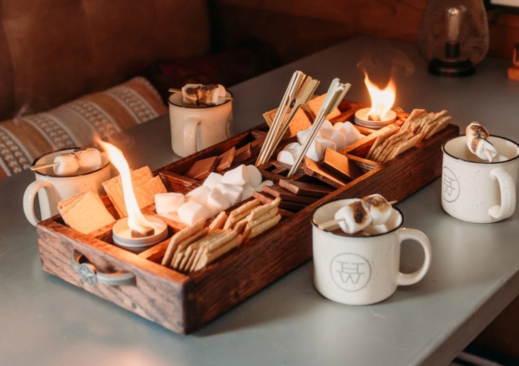 A large board with a display of crackers, marshmallows, and chocolate